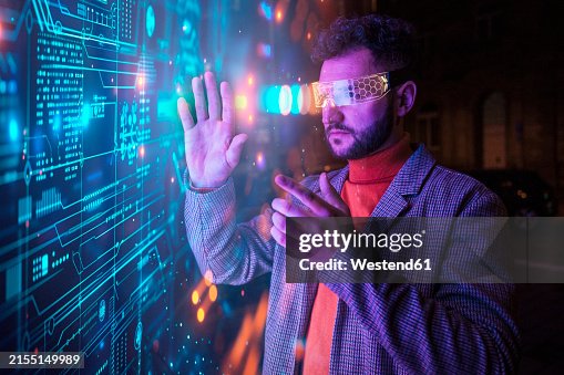Engineer gesturing with smart glasses and examining big data Engineer gesturing with smart glasses and examining big data
