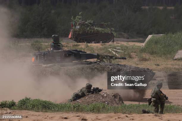 Puma infantry fighting vehicle and a Wiesel tracked vehicle of the Bundeswehr, the German armed forces, participate in the Quadriga military...