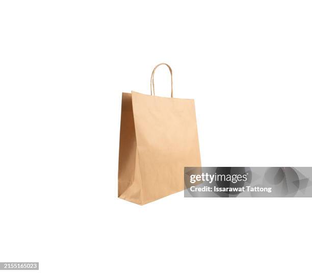 a brown paper bag is sitting on a white background - brown paper shopping bag stock pictures, royalty-free photos & images