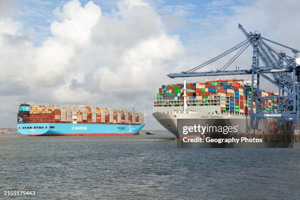 Ane Maersk container ship arriving at Port of Felixstowe, Suffolk, England, UK OOCL Zeebrugge at quayside.