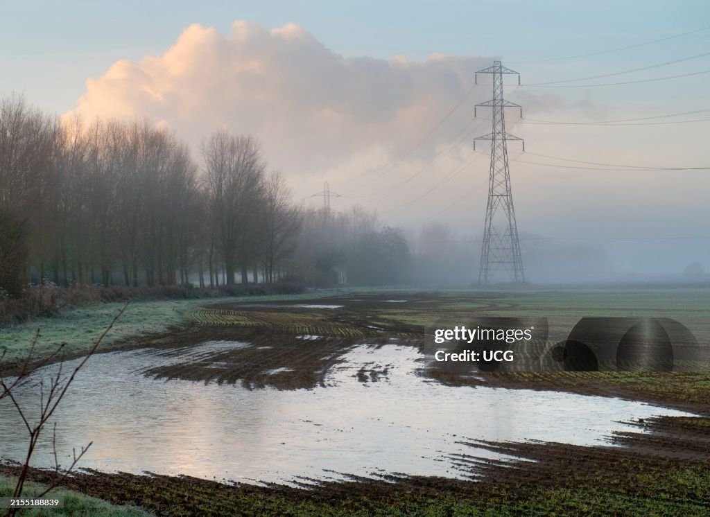 Electricity pylon in a field in Lower Radley, veiled in winter morning mists