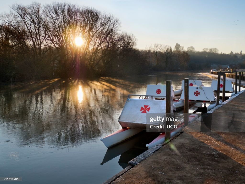 Row of pleasure boats at Radley Boathouse by the Thames, winter sunrise