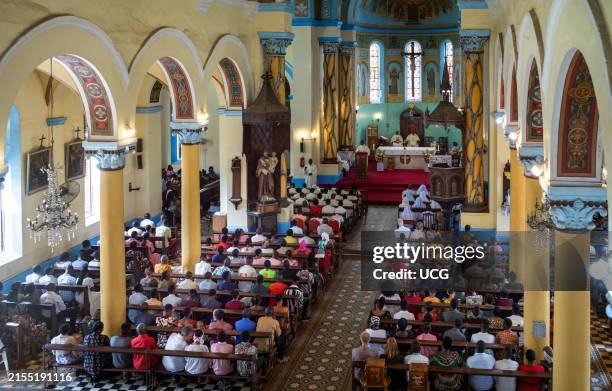 High view of the colorful congregation at catholic Sunday Mass in St Joseph's Cathedral, Stone Town, Zanzibar, Tanzania.