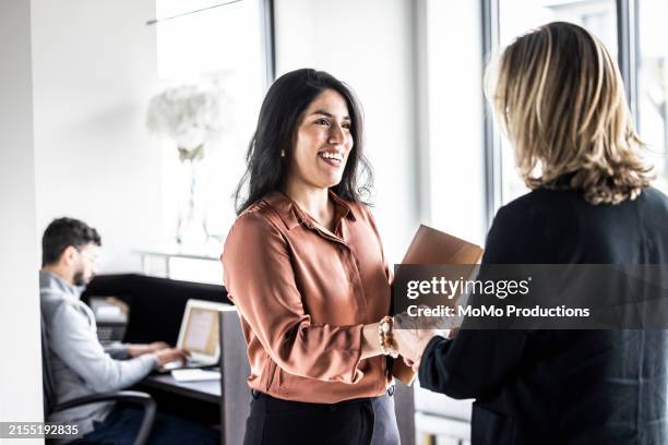 businesswomen meeting in lobby of modern office - recruitment stock pictures, royalty-free photos & images