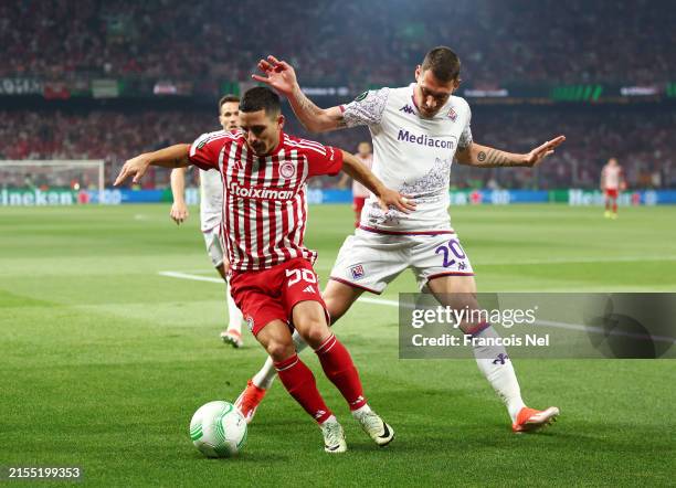 Daniel Podence of Olympiacos is challenged by Andrea Belotti of ACF Fiorentina during the UEFA Europa Conference League 2023/24 final match between...