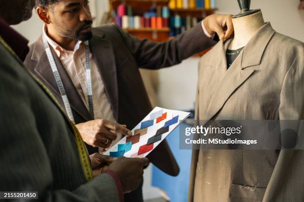 latin senior tailor working with client in studio - tailored stock pictures, royalty-free photos & images
