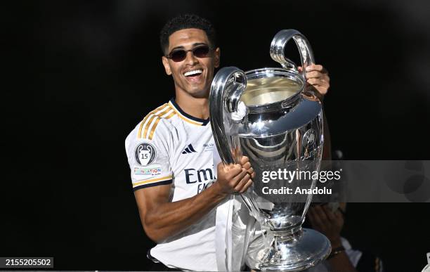 Jude Bellingham of Real Madrid raises the trophy during Real Madrid UEFA Champions League Trophy Parade celebrating their victory of 15th Champions...