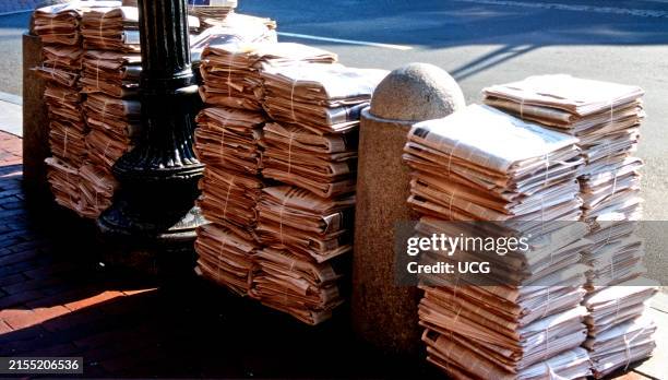 Sunday Morning Newspapers on a City Sidewalk.