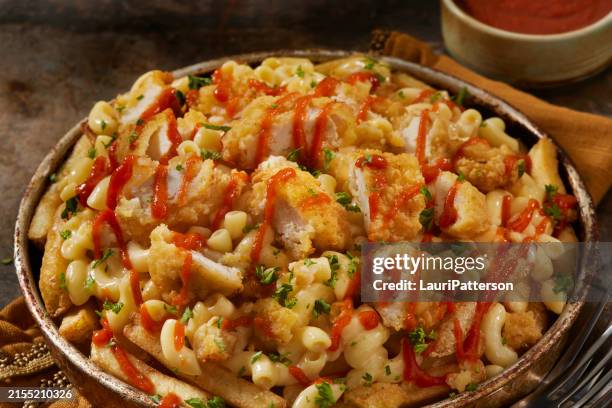 mac and cheese fries with fried chicken tenders - fried chicken tenders stock pictures, royalty-free photos & images