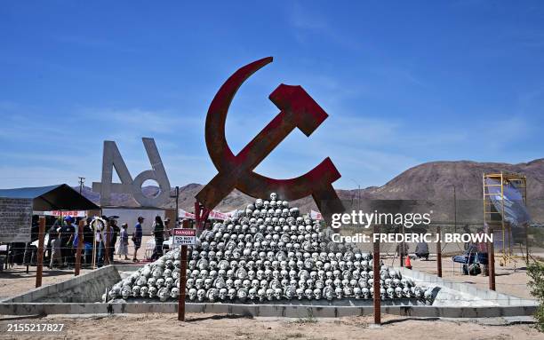People discover the newly unveiled sculpture "Monument to the Victims of Communism" by artist Chen Weiming as they gather to commemorate the 35th...