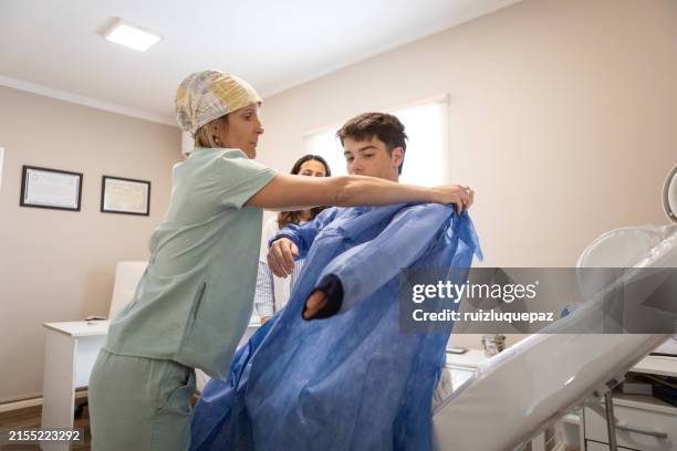 nurse preparing her patient for a dermatological check-up - preventive care stock pictures, royalty-free photos & images