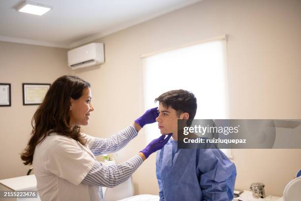 dermatologist explaining to her patient the medical procedures to be performed - dermatology stock pictures, royalty-free photos & images