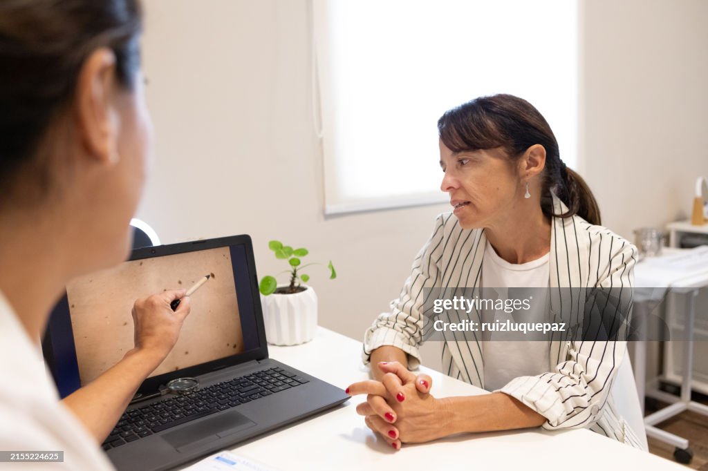 Dermatologist in consultation with female patient