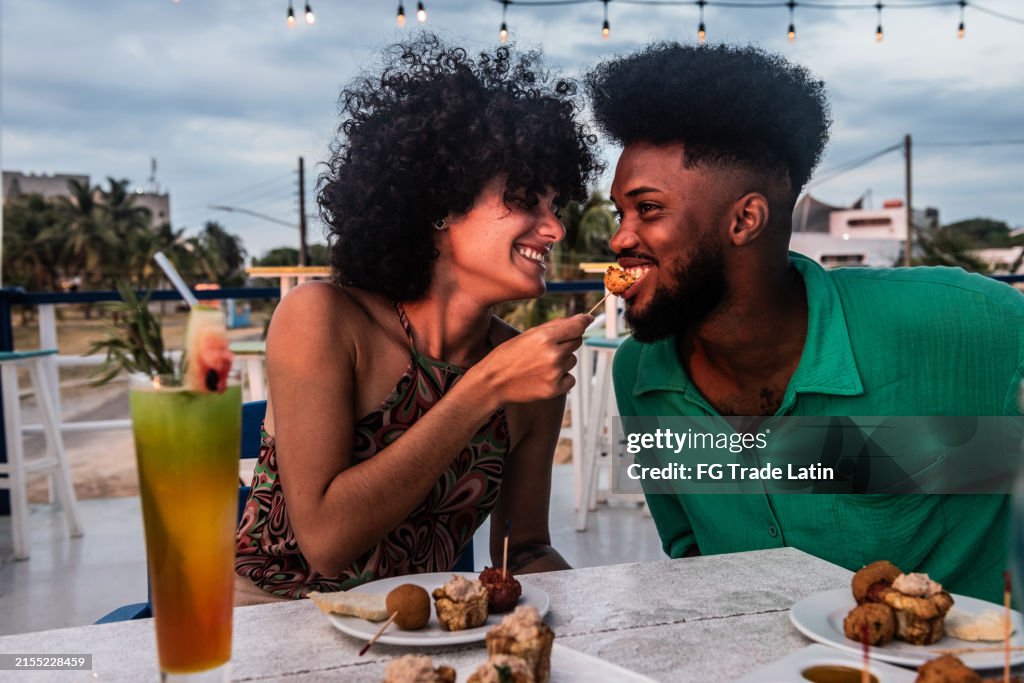 Happy couple talking and eating on a restaurant