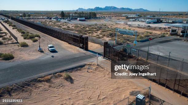 the united states border wall in new mexico at the us customs and border protection santa teresa port of entry with a border patrol vehicle standing watch - deportation stock pictures, royalty-free photos & images
