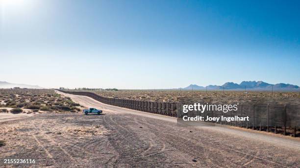 a border patrol vehicle stands watch at the mexican american border wall outside of el paso texas - mexico wall stock pictures, royalty-free photos & images