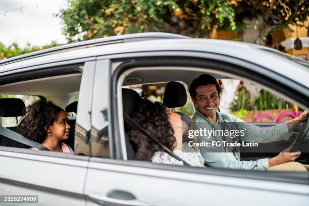 happy family talking inside a car - happy mexican family stock pictures, royalty-free photos & images