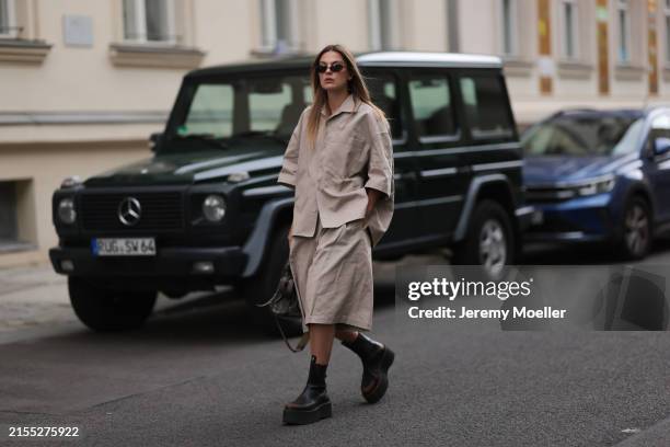 Alessa Winter seen wearing Balenciaga black oval sunglasses, Studio Seidensticker beige short sleeves buttoned shirt, matching Studio Seidensticker...