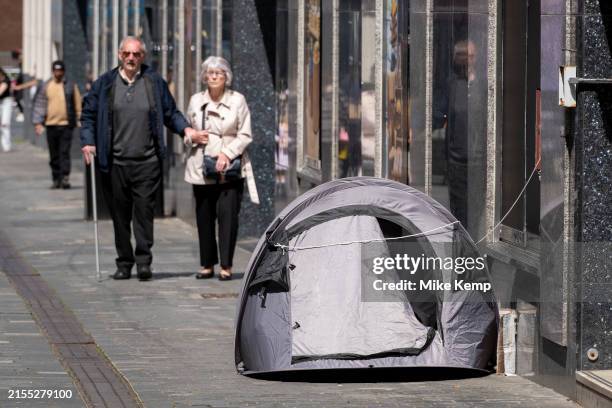 Homeless person's tent on the pavement as people pass by on 30th May 2024 in Liverpool, United Kingdom. The scene is illustrative of the social...