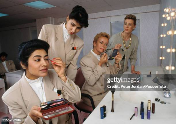 Emirates Airlines staff learning to apply make-up in Dubai, United Arab Emirates, circa 1990.