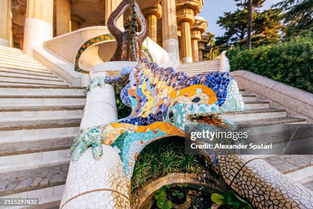 colourful mosaic lizard on a dragon stairway in park guell, barcelona, spain - lizard stock pictures, royalty-free photos & images