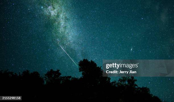 the milky way and the perseid meteor shower at night - meteor shower stock pictures, royalty-free photos & images