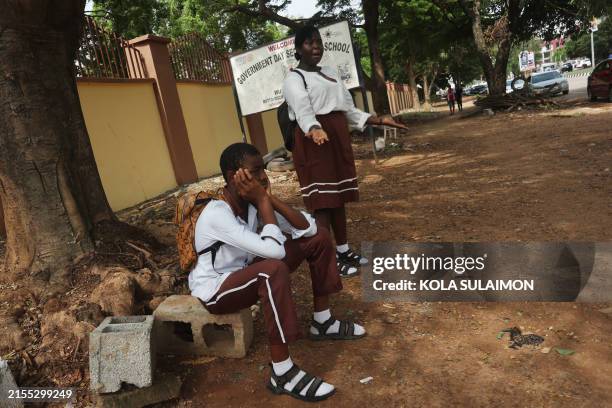 Schoolchildren of the Government Science Secondary School react while stranded outside their school after the Nigerian unions began an indefinite...
