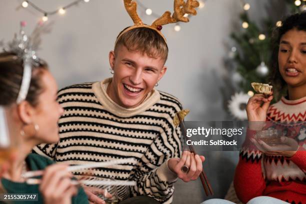 students having fun at christmas - christmas asian food stock pictures, royalty-free photos & images