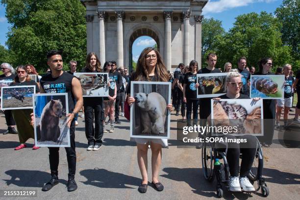 Activists hold placards front of the Wellington Arch during the commemoration. The National Animal Rights Day, observed in over 50 countries around...
