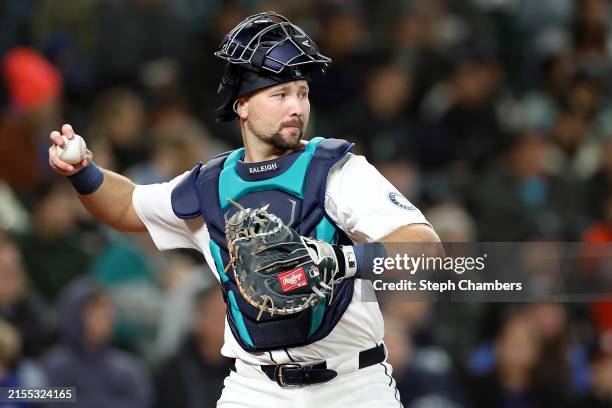 Cal Raleigh of the Seattle Mariners fields the ball against the Houston Astros at T-Mobile Park on May 29, 2024 in Seattle, Washington.