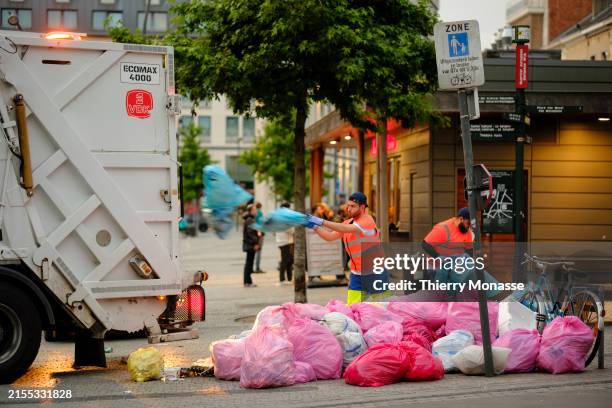 Rubbish collectors remove trash bags in Jourdan square on June 3, 2024 in Brussels, Belgium.