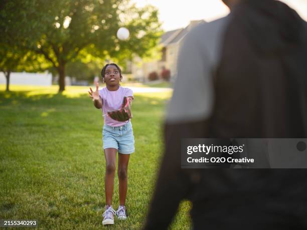 grandfather and granddaughter practicing baseball in a park - grandpa playing catch stock pictures, royalty-free photos & images