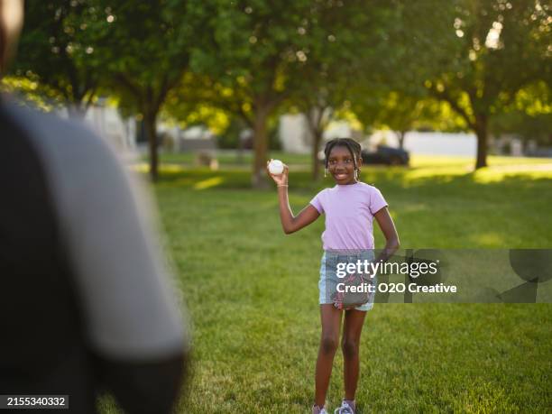 grandfather and granddaughter practicing baseball in a park - grandpa playing catch stock pictures, royalty-free photos & images
