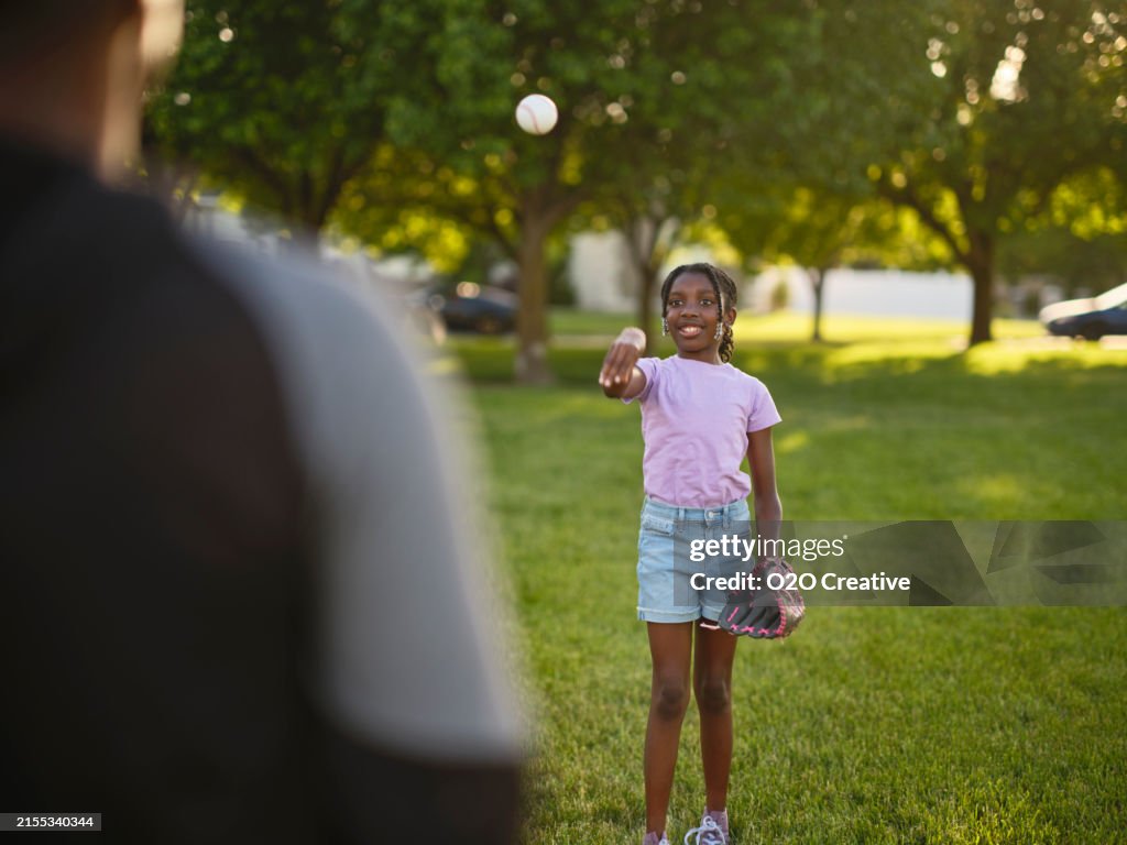 Grandfather and Granddaughter Practicing Baseball in a Park