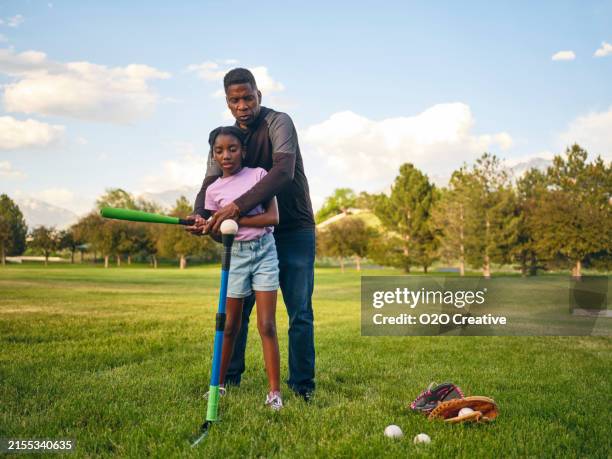 grandfather and granddaughter practicing baseball in a park - black baseball player stock pictures, royalty-free photos & images