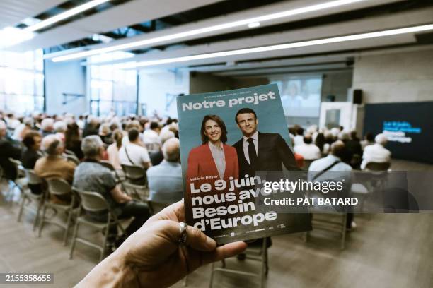 Program with Valerie Hayer and Emmanuel Macron on its cover during the public meeting in support of the Renaissance list for the next European...