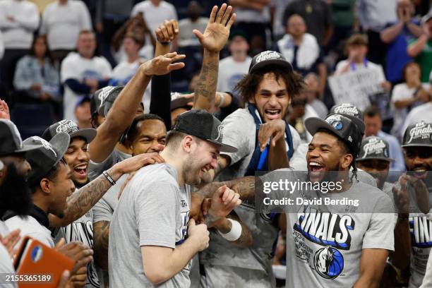 Luka Doncic of the Dallas Mavericks celebrates with teammates after a 124-103 victory against the Minnesota Timberwolves in Game Five of the Western...