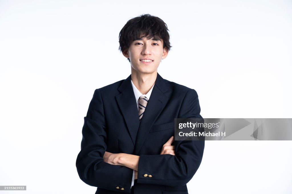 Portrait of a male high school student with his arms crossed