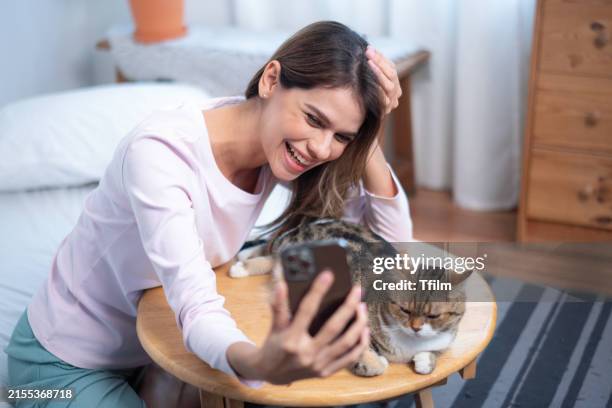 woman taking selfie with cat at home - dog selfie asian stock pictures, royalty-free photos & images