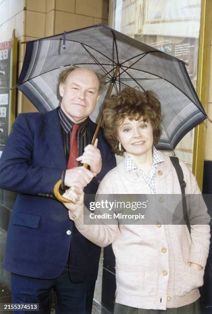 Actor Timothy West and his wife, actress Prunella Scales, share an umbrella as they brave the rain in Manchester to promote their latest venture, the...