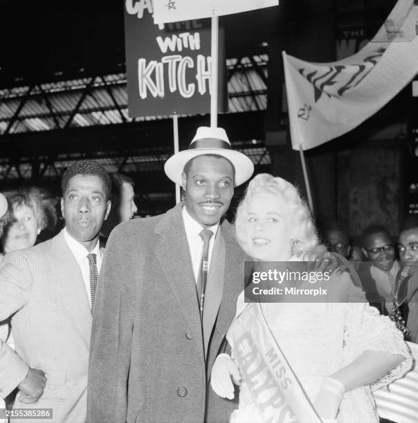 Lord Kitchener - dressed in his long coat and white hat - is met by fans on his return to London Waterloo Station on the New Amsterdam boat train...