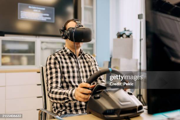 male university student testing video game at computer lab - simulator stock pictures, royalty-free photos & images