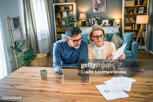 Mature couple manages expenses and bills Mature couple manages expenses and bills
