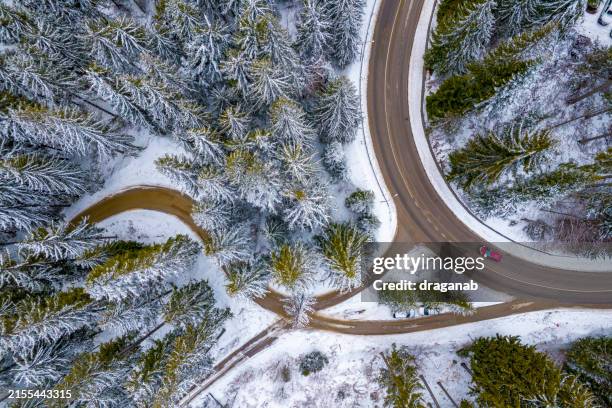 curved crossroad in a snowy mountain - mountain road stock pictures, royalty-free photos & images