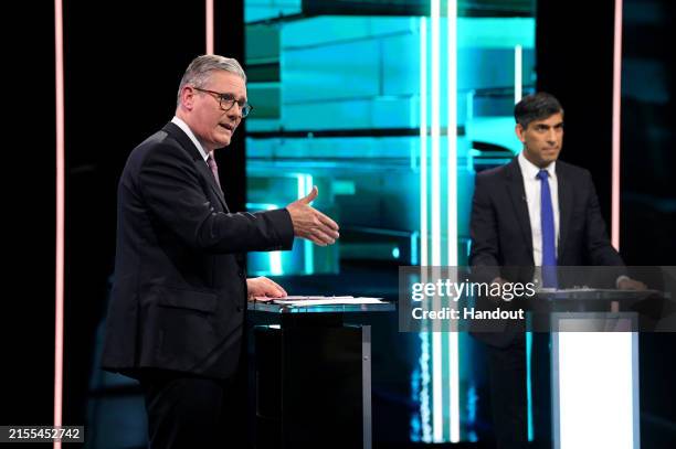 In this handout provided by ITV, Labour Party leader Keir Starmer and Prime Minister Rishi Sunak speak on stage during the first head-to-head debate...