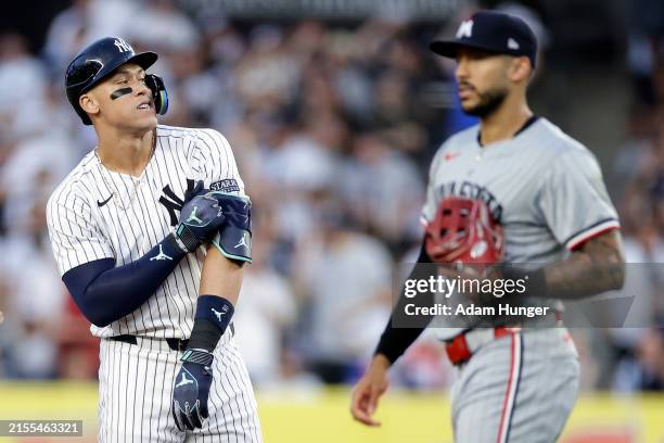 Aaron Judge of the New York Yankees reacts after hitting a 2-run scoring double in front of Carlos Correa of the Minnesota Twins pitches during the...
