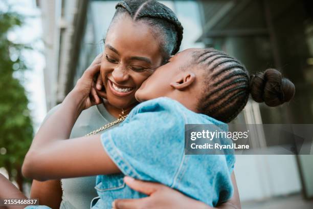 daughter kisses her mother - mother and daughter kissing stock pictures, royalty-free photos & images