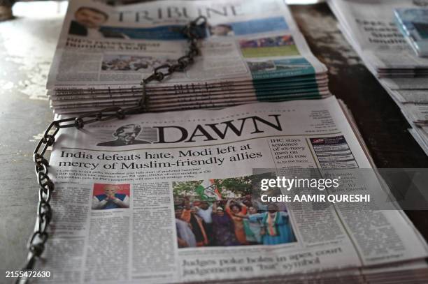 Pakistan's newspapers with front page of India's general election results are pictured along a street in Islamabad on June 5, 2024. The alliance led...