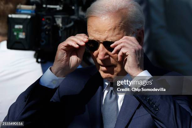 President Joe Biden puts on his aviator sunglasses while hosting the NFL Super Bowl champions Kansas City Chiefs on the South Lawn of the White House...