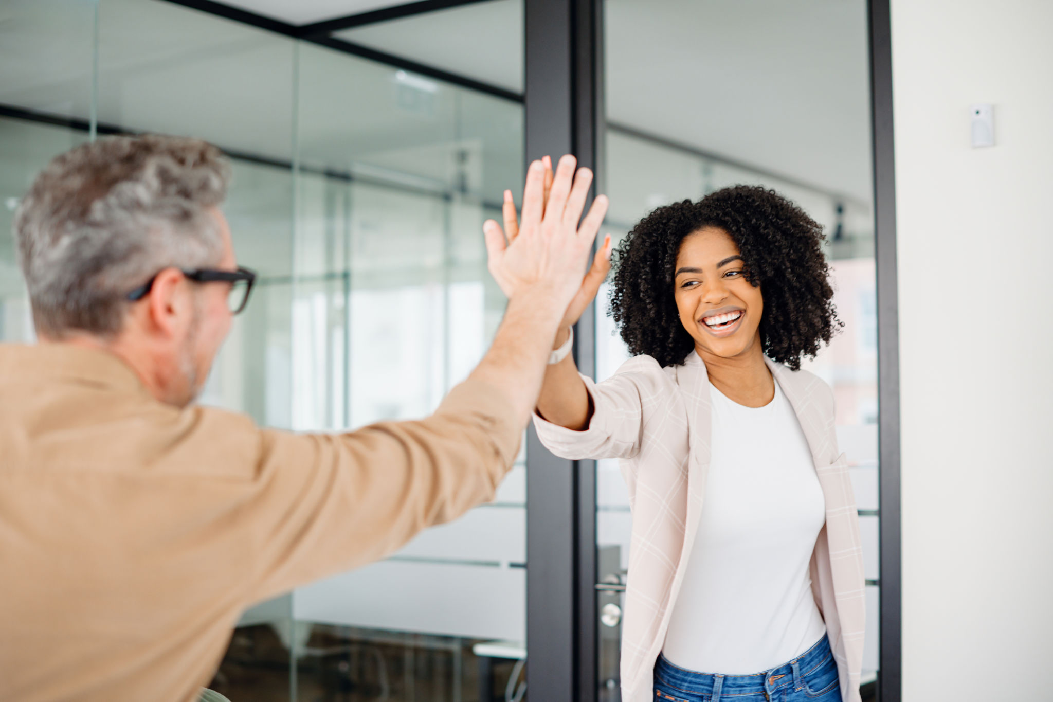 The colleagues exchange a high-five after happy coefficients of marketing mix modelling achieved The colleagues exchange a high-five after happy coefficients of marketing mix modelling achieved